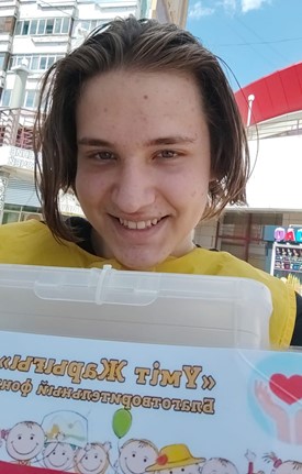 A student proudly working for orphaned children with disabilities at a charity foundation. A student proudly working for orphaned children with disabilities at a charity foundation.