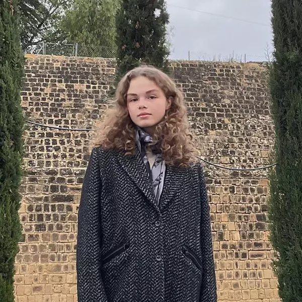 A happy student discussing their positive learning experience at Matrix Academy, highlighting the benefits of real-life applications, supportive teachers, live interactive classes and global community.